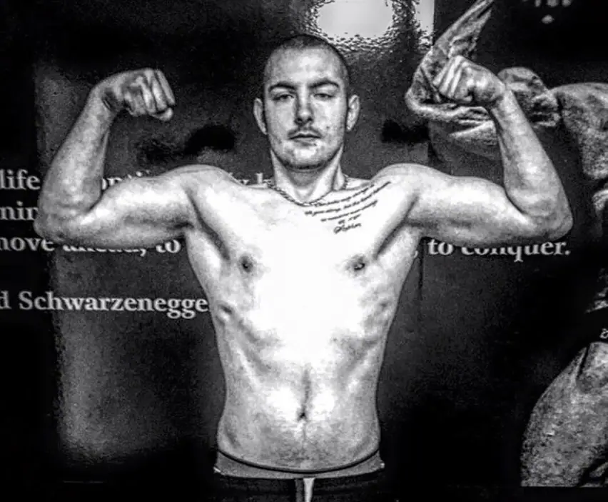 Eoin Henry flexing, black and white